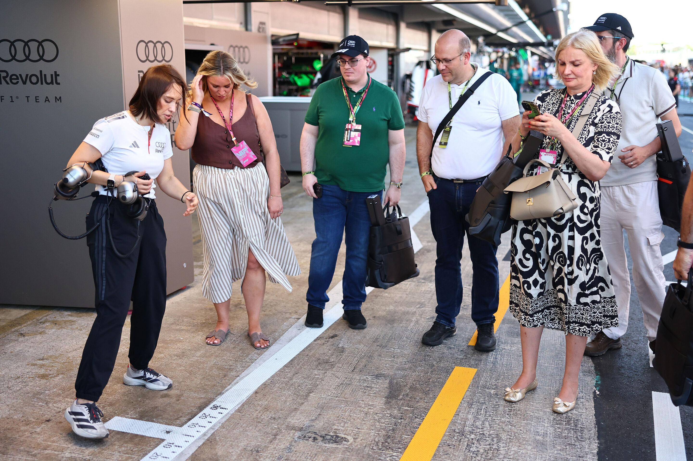 2026 Grand Prix de Barcelona - Guests - BARCELONA, SPAIN - JUNE 13: Audi F1 Team team member in the Pitlane with guests during qualifying ahead of the F1 Grand Prix of Barcelona-Catalunya at Circuit de Barcelona-Catalunya on June 13, 2026 in Barcelona,...