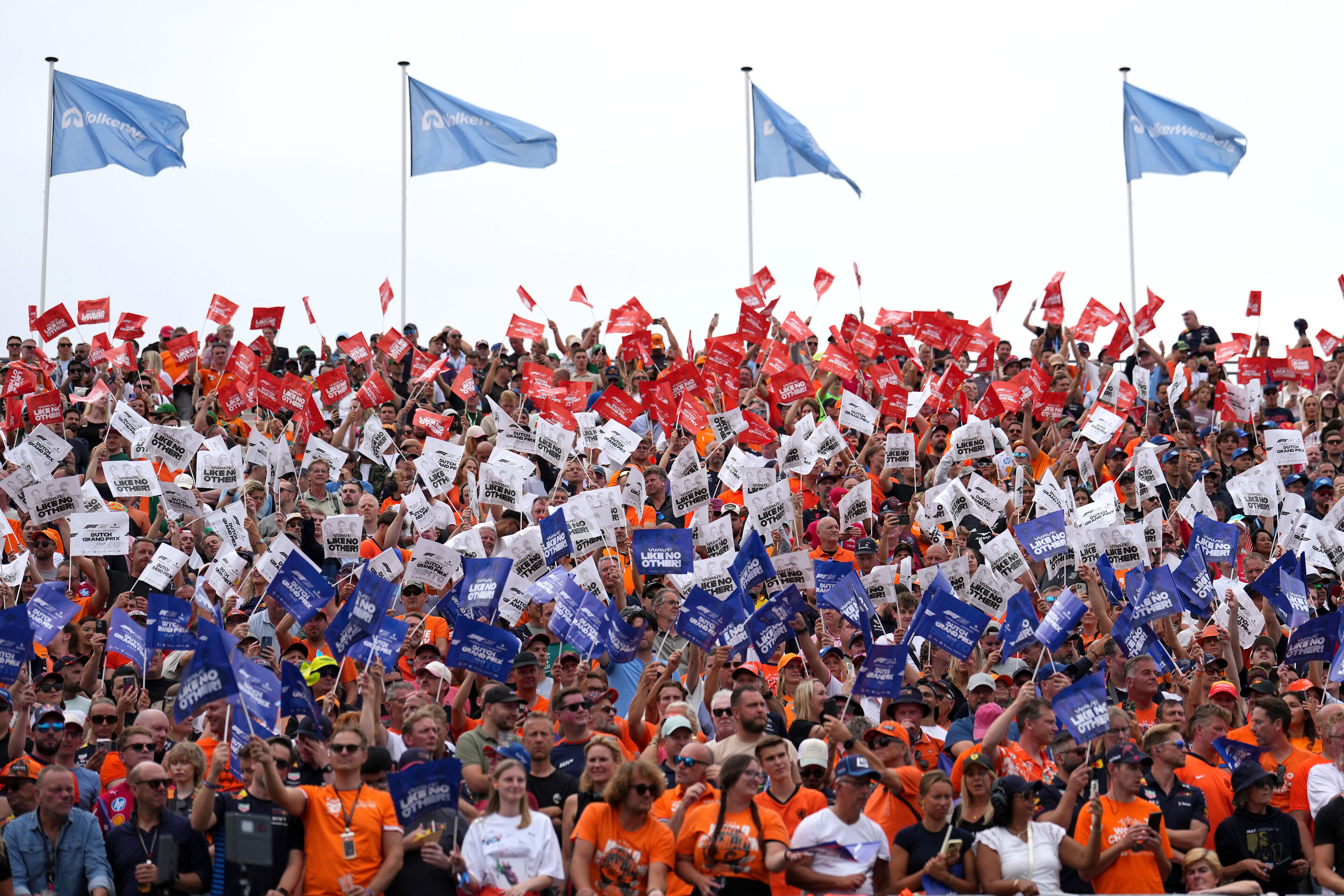 2233143748 - ZANDVOORT, NETHERLANDS - AUGUST 31: Fans wave flags ahead of the F1 Grand Prix of Netherlands at Circuit Zandvoort on August 31, 2025 in Zandvoort, Netherlands. (Photo by Alex Bierens de Haan/Getty Images)