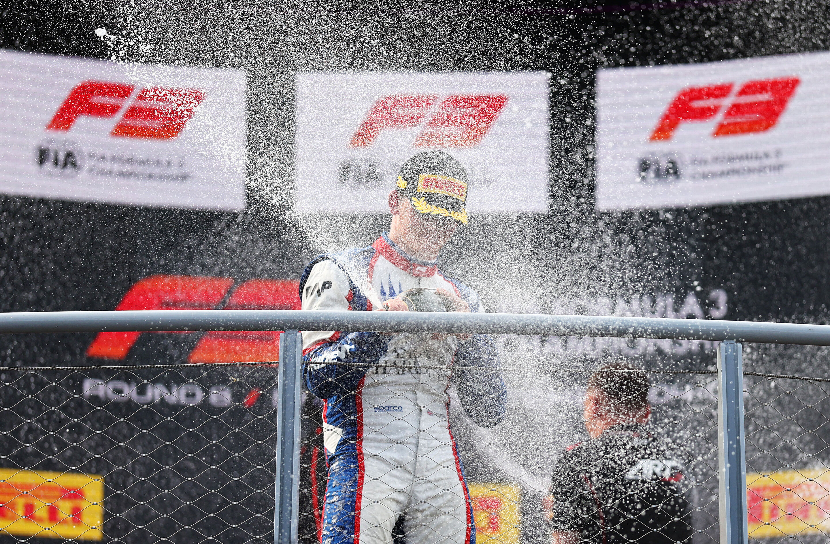 2026 Italian Grand Prix - F3 - MONZA, ITALY - SEPTEMBER 05: Second placed Freddie Slater of Great Britain and TRIDENT (5) and Audi F1 Team celebrates with Champagne on the podium during the Round 8 Monza Sprint race of the Formula 3 Championship at Autodromo...
