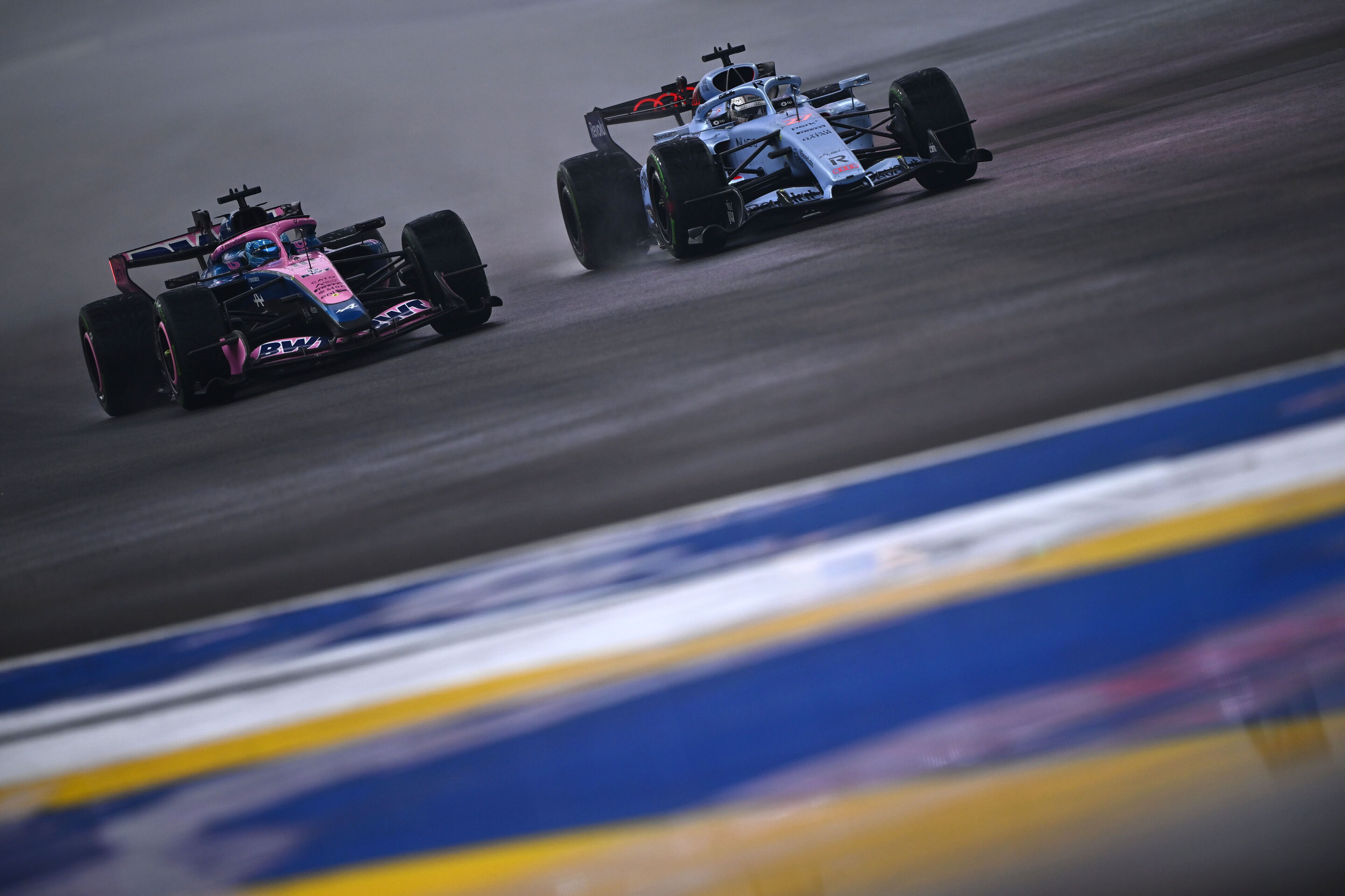 F1 Grand Prix Of Singapore - Sprint & Qualifying - SINGAPORE, SINGAPORE - OCTOBER 10: Pierre Gasly of France driving the (10) Alpine F1 A526 Mercedes and Nico Hulkenberg of Germany driving the (27) Audi F1 Team R26 battle for track position during the...