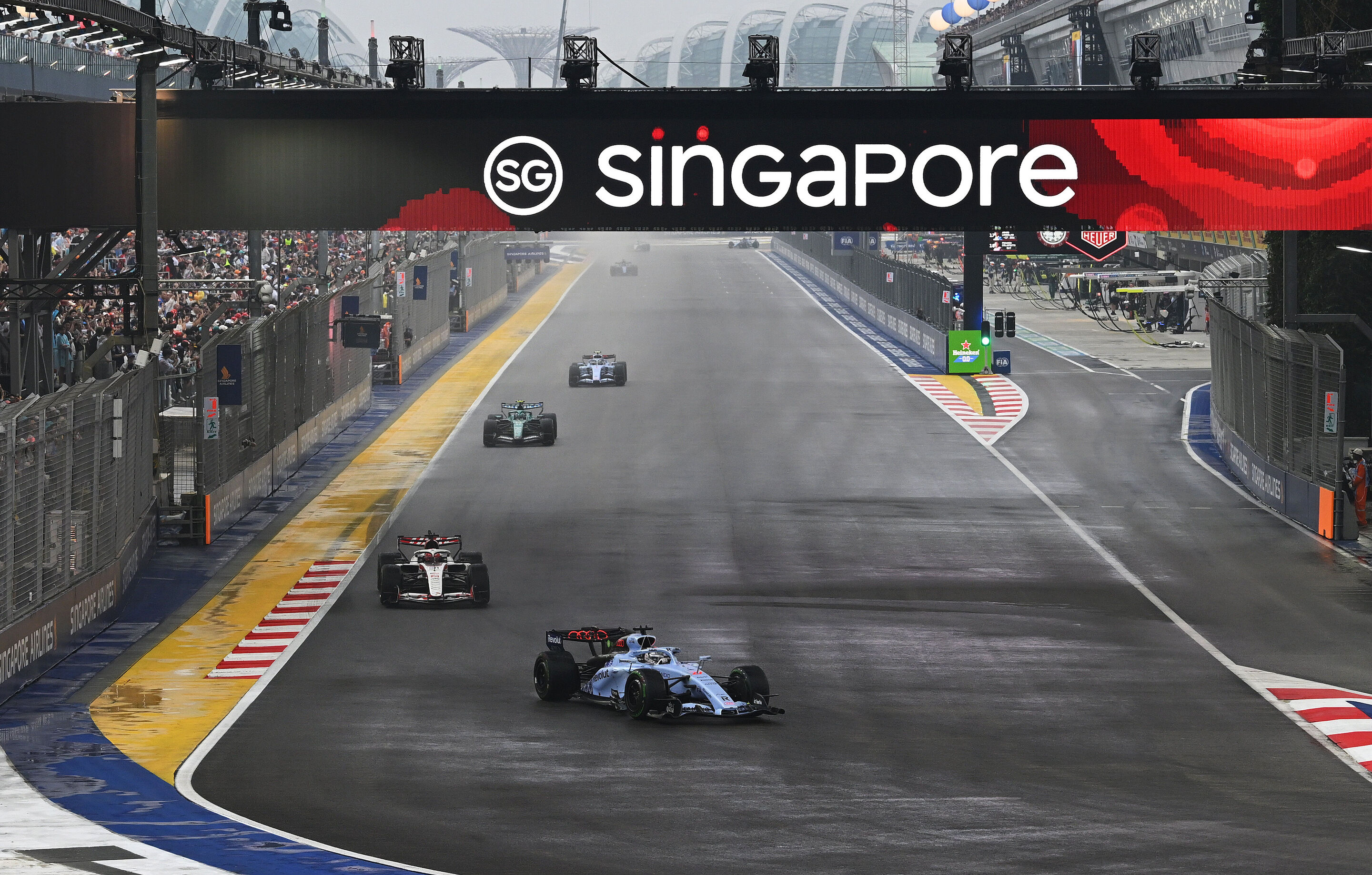 F1 Grand Prix Of Singapore - Sprint & Qualifying - SINGAPORE, SINGAPORE - OCTOBER 10: Nico Hulkenberg of Germany driving the (27) Audi F1 Team R26 leads Esteban Ocon of France driving the (31) Haas F1 VF-26 Ferrari on track during the Sprint ahead of...